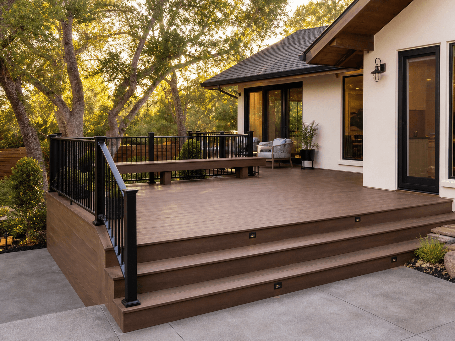 Completed composite deck with black railing and wide steps